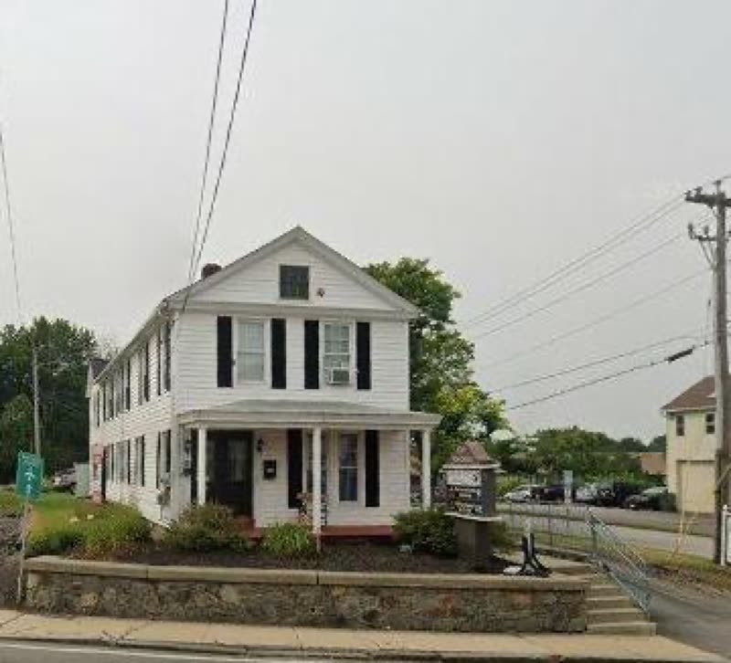 The white clapboard building on S Main Street where the grooming shop is